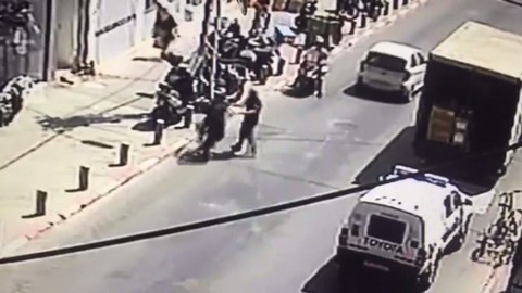 שוטר מתקרב לרוכב אופניים חשמליים לאחר שהורה לו לעצור